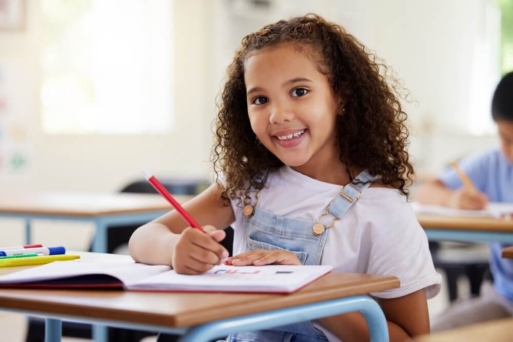 Preschool smile, development and happy kid or student coloring for creative art in notebook in kindergarten